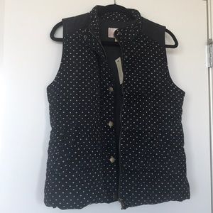 Black puffer vest with white polka dots